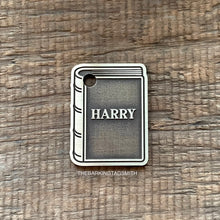 Load image into Gallery viewer, Dog ID tag shaped like a book with the name Harry deep engraved, personalised engraved metal pet tag for book lovers with a classic storybook design.