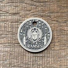 Load image into Gallery viewer, Dog ID tag with Egyptian scarab and hieroglyph design deep engraved on round metal tag, personalised engraved pet tag featuring Ramses.