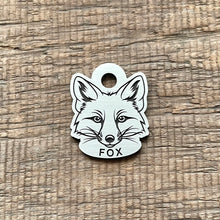 Load image into Gallery viewer, Dog ID tag shaped like a fox head with detailed deep engraved fox face design, personalised engraved metal pet tag for wildlife and nature lovers.