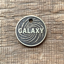 Load image into Gallery viewer, Dog ID tag with swirling galaxy design and engraved name, personalised deep engraved metal pet tag with cosmic space pattern.