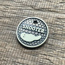 Load image into Gallery viewer, Personalised golf ball dog ID tag with engraved golf ball dimple texture and golf green design in brushed silver metal on rustic wood background