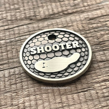 Load image into Gallery viewer, Personalised golf ball dog ID tag with engraved golf ball dimple texture and golf green design in brushed silver metal on rustic wood background