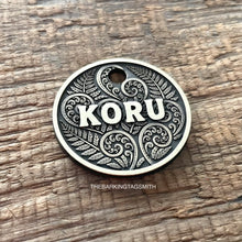 Load image into Gallery viewer, Dog ID tag with koru and fern design and engraved name Koru, personalised deep engraved metal pet tag inspired by New Zealand patterns.
