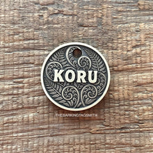 Load image into Gallery viewer, Dog ID tag with koru and fern design and engraved name Koru, personalised deep engraved metal pet tag inspired by New Zealand patterns.