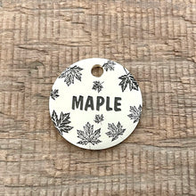 Load image into Gallery viewer, Personalised maple leaf dog ID tag with engraved autumn maple leaf pattern and Maple name in brushed silver metal on rustic wood background
