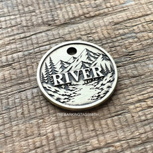 Load image into Gallery viewer, Personalised mountain river dog ID tag with engraved forest, flowing river and mountain landscape in brushed silver metal on rustic wood background