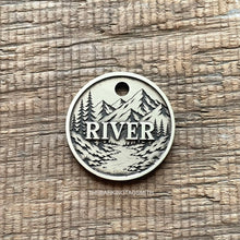 Load image into Gallery viewer, Personalised mountain river dog ID tag with engraved forest, flowing river and mountain landscape in brushed silver metal on rustic wood background