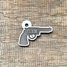 Load image into Gallery viewer, Dog ID tag shaped like a revolver pistol with the name Clyde deep engraved, personalised engraved metal pet tag with bold western style design.