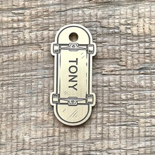 Load image into Gallery viewer, Dog ID tag shaped like a skateboard with engraved trucks and wheels, personalised metal pet tag with the name Tony.