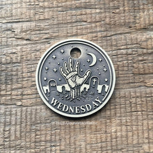 Load image into Gallery viewer, Dog ID tag with zombie hand rising from a graveyard deep engraved on round metal tag, personalised engraved pet tag inspired by Wednesday gothic style.