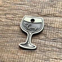 Load image into Gallery viewer, Dog ID tag shaped like a wine glass with the name Ginny engraved, personalised metal pet tag with deep engraving on brushed brass finish.